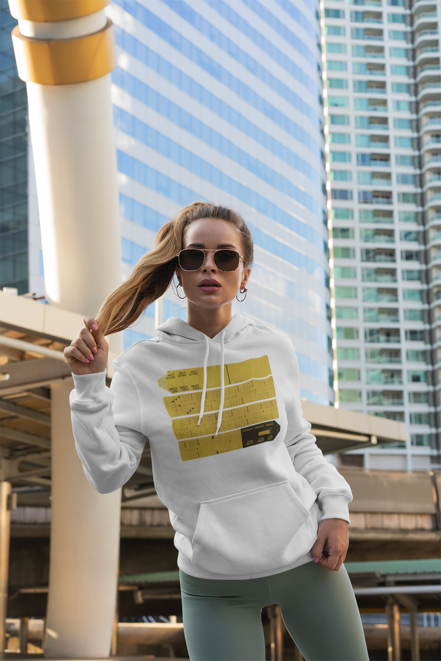 pullover-hoodie-mockup-featuring-a-woman-posing-in-front-of-some-tall-buildings-3554-el1.png